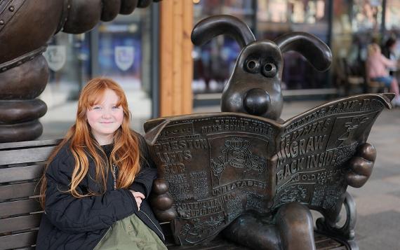 Girl sat next to Gromit