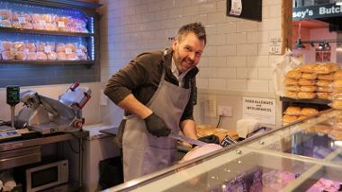 Trader cutting meat