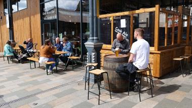 People enjoying drinks in the sun