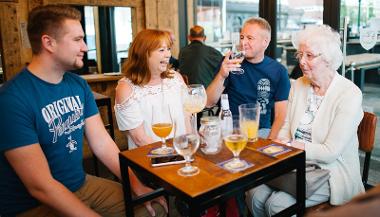 Customers sat around a table enjoying drinks