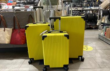 Wheeled yellow suitcases