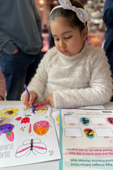 Girl colouring at craft table