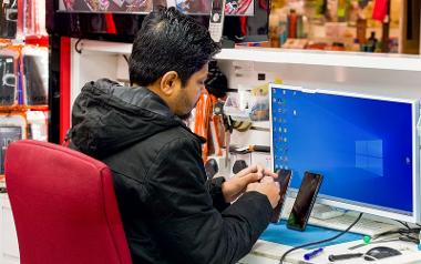 Trader repairing phones