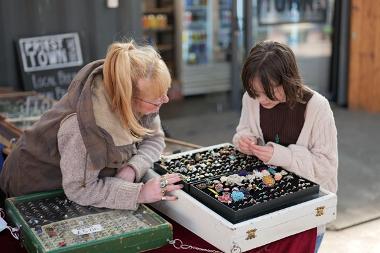 Trader looking through vintage items with child