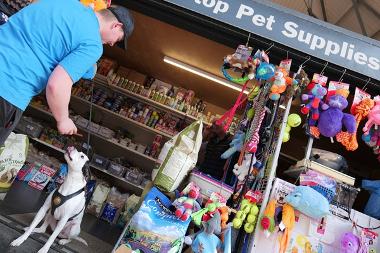 Customer with pet dog at stall